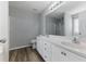 Bathroom featuring a double vanity with white cabinets and a shower with glass doors at 840 Franklin Mill Trce, Loganville, GA 30052