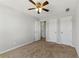 Carpeted bedroom featuring a ceiling fan, neutral paint, and plenty of closet space at 840 Franklin Mill Trce, Loganville, GA 30052
