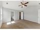 Bright bedroom with neutral walls, a ceiling fan, carpet flooring, and an ensuite bathroom at 840 Franklin Mill Trce, Loganville, GA 30052