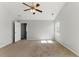 Spacious bedroom featuring a ceiling fan, neutral walls, carpet flooring, and natural light from a window at 840 Franklin Mill Trce, Loganville, GA 30052