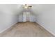 Spacious bonus room featuring neutral carpet, a ceiling fan, and a door to another room at 840 Franklin Mill Trce, Loganville, GA 30052