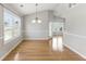 Bright dining area featuring hardwood floors and a stylish chandelier at 840 Franklin Mill Trce, Loganville, GA 30052