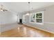 Open concept dining area featuring wood floors with large windows for natural light at 840 Franklin Mill Trce, Loganville, GA 30052