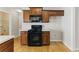 Well-maintained kitchen featuring wooden cabinets, black appliances, and laminate countertops at 840 Franklin Mill Trce, Loganville, GA 30052