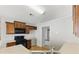 A kitchen features wooden cabinets, light countertops, black gas range, microwave, and stainless steel sink at 840 Franklin Mill Trce, Loganville, GA 30052