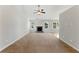 Bright living room featuring a stone fireplace, ceiling fan and large windows at 840 Franklin Mill Trce, Loganville, GA 30052