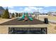 Community playground featuring green slides and play structure on a bed of mulch, bordered by a black bench at 840 Franklin Mill Trce, Loganville, GA 30052