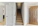 Foyer featuring carpeted stairs, a white interior door, and an exterior brown door at 840 Franklin Mill Trce, Loganville, GA 30052