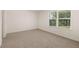 A well-lit bedroom features a large window and neutral-toned walls at 1088 Blue Juniper Cir, Loganville, GA 30052