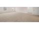 Large bedroom with neutral carpet, white walls, and multiple doors at 1088 Blue Juniper Cir, Loganville, GA 30052