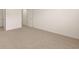 Spacious carpeted bedroom featuring a neutral color scheme and minimalist design at 1088 Blue Juniper Cir, Loganville, GA 30052