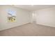 Well-lit carpeted bedroom with a window and view into a walk-in closet at 1088 Blue Juniper Cir, Loganville, GA 30052