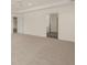 Bright bedroom with neutral carpet, white walls, and access to additional rooms at 1088 Blue Juniper Cir, Loganville, GA 30052
