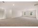 Upstairs bonus room with carpet and natural light at 1088 Blue Juniper Cir, Loganville, GA 30052