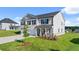 Angle view of two-story home with stone and siding, two-car garage, and green lawn at 1088 Blue Juniper Cir, Loganville, GA 30052