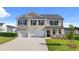 Beautiful two-story home with brick and siding exterior, two-car garage, and well-manicured lawn at 1088 Blue Juniper Cir, Loganville, GA 30052