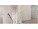 Upstairs hallway with stairway and doorway into bedroom at 1088 Blue Juniper Cir, Loganville, GA 30052