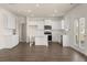 Bright kitchen features white cabinets, island, stainless steel appliances, and hardwood floors at 1088 Blue Juniper Cir, Loganville, GA 30052