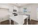 Kitchen with white cabinets, countertops and island with stainless steel appliances and hardwood floors at 1088 Blue Juniper Cir, Loganville, GA 30052