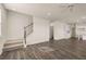 Open-concept living room with staircase and view into the adjacent kitchen and dining area at 1088 Blue Juniper Cir, Loganville, GA 30052