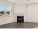 Living room featuring a fireplace and large window, offering a cozy and well-lit space at 1088 Blue Juniper Cir, Loganville, GA 30052