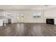 Open living room with fireplace, stainless steel appliances, and access to the outdoors through French doors at 1088 Blue Juniper Cir, Loganville, GA 30052