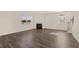 Bright living room with dark wood floors, fireplace, and staircase with natural light streaming through large windows at 1088 Blue Juniper Cir, Loganville, GA 30052