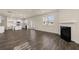 Spacious living room with wood floors, open to the kitchen, and featuring a fireplace at 1088 Blue Juniper Cir, Loganville, GA 30052