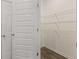 Open pantry with shelving and hardwood floors at 1088 Blue Juniper Cir, Loganville, GA 30052