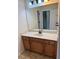 Bathroom with a big mirror, white counter, and honey-colored cabinets at 2530 Gold Creek Ln, Cumming, GA 30041