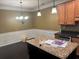Open kitchen featuring granite counters, stainless steel appliances, and a decorative chandelier at 2530 Gold Creek Ln, Cumming, GA 30041
