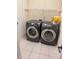 Convenient laundry room equipped with a washer and dryer, plus overhead storage at 2530 Gold Creek Ln, Cumming, GA 30041