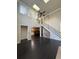 Bright living room with dark wood floors, cathedral ceilings, and views to the kitchen and stairway at 2530 Gold Creek Ln, Cumming, GA 30041