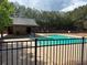 Community pool and pool house surrounded by tall trees, offering a refreshing escape on warm days at 2530 Gold Creek Ln, Cumming, GA 30041