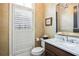 Stylish powder room features decorative wallpaper, custom vanity, and plantation shutters at 4 Candler Grove Dr, Decatur, GA 30030