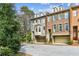Townhome exterior featuring brick facade, dormers, and a well-manicured lawn at 4 Candler Grove Dr, Decatur, GA 30030