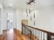 Upstairs hallway with wood floors, stylish lighting and view to a home office at 4 Candler Grove Dr, Decatur, GA 30030