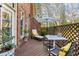 Charming deck with comfortable lounge chairs, dining set, and views of the surrounding wooded area at 4 Candler Grove Dr, Decatur, GA 30030