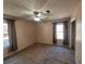 Bright bedroom with carpet, ceiling fan, and large windows at 74 Sandy Path, Rockmart, GA 30153