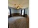 A carpeted bedroom with ample light, ceiling fan, and wood paneling at 74 Sandy Path, Rockmart, GA 30153