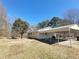 Exterior view of single-story home with car port featuring a well maintained lawn and gravel driveway at 74 Sandy Path, Rockmart, GA 30153