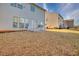 This spacious backyard has green grass and a patio with white furniture at 1340 Aster Ives Dr, Lawrenceville, GA 30045