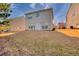 This spacious backyard has green grass and a patio with white furniture at 1340 Aster Ives Dr, Lawrenceville, GA 30045