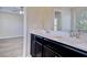 Bathroom with double sink vanity, mirror and view of the bedroom at 1340 Aster Ives Dr, Lawrenceville, GA 30045
