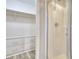 Bathroom featuring a glass door shower and walk-in closet with built-in shelves at 1340 Aster Ives Dr, Lawrenceville, GA 30045