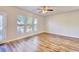 Bright, airy bedroom with wood-look floors, multiple windows, and a ceiling fan at 1340 Aster Ives Dr, Lawrenceville, GA 30045