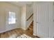Welcoming entryway with wood-look floors, a staircase, and a door with natural light at 1340 Aster Ives Dr, Lawrenceville, GA 30045