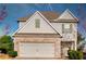 Charming two-story home with a brick facade and a two-car garage on a sunny day at 1340 Aster Ives Dr, Lawrenceville, GA 30045