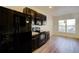 Modern kitchen features dark cabinetry, stainless steel appliances, and hardwood flooring at 1340 Aster Ives Dr, Lawrenceville, GA 30045