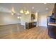 Open-concept kitchen featuring dark cabinetry, a breakfast bar, and wood-look flooring at 1340 Aster Ives Dr, Lawrenceville, GA 30045